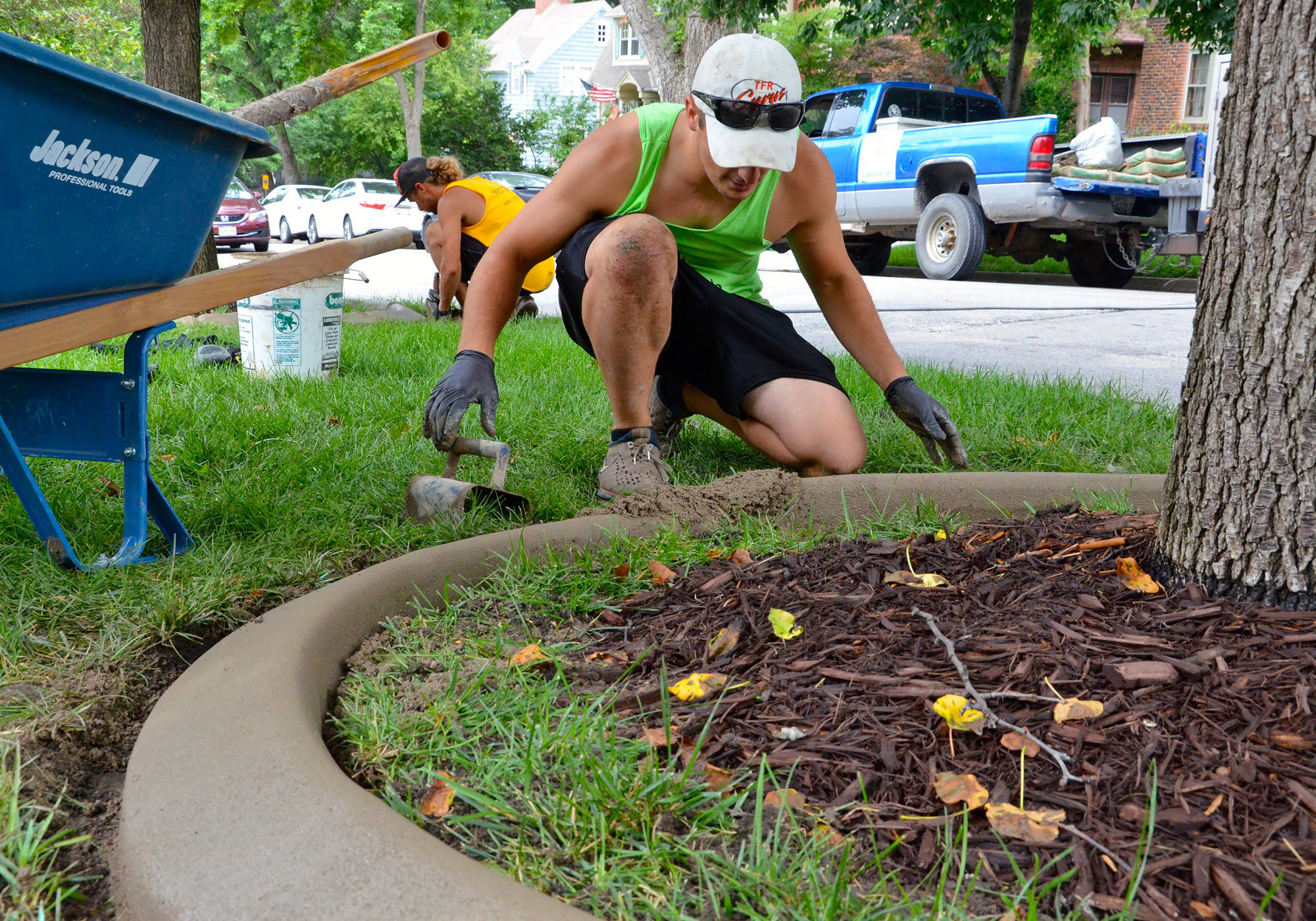 A professional working on a landscape edging setup in Omaha, NE
